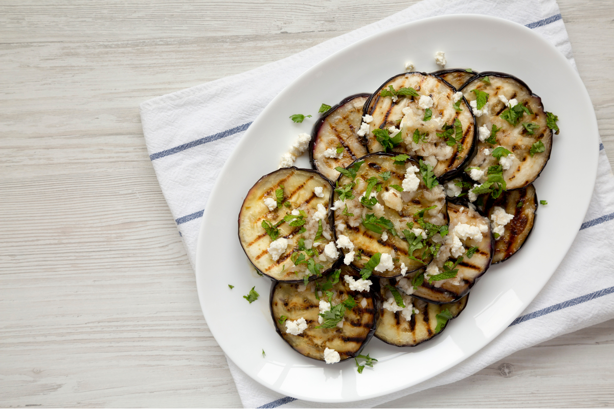 Weight Watchers Grilled Greek Eggplant on a white plate sitting on a light colored surface.