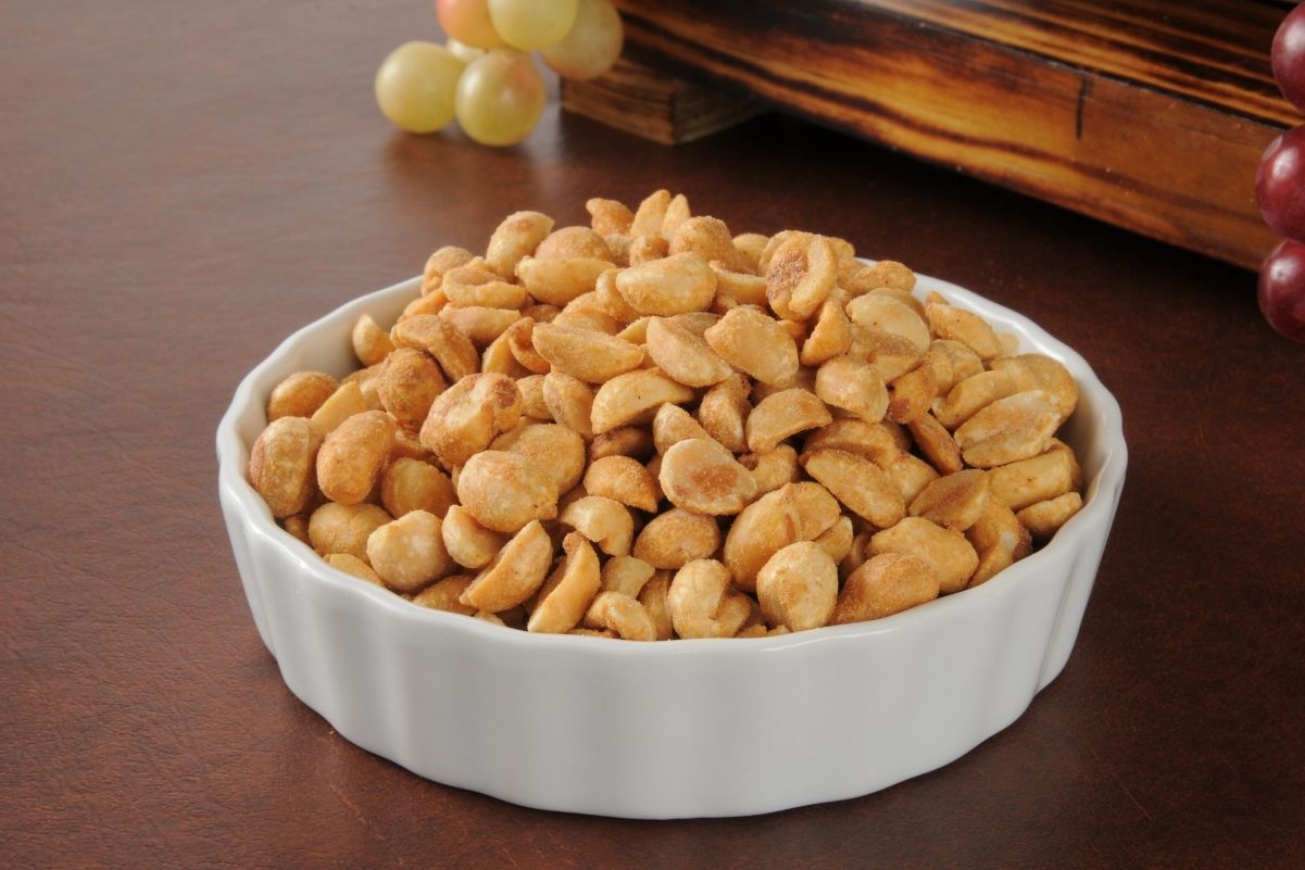 Honey Roasted peanuts in a circular, white dish.
