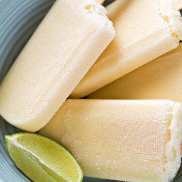 Closeup of Creamy Weight Watchers Key Lime Popsicles in a blue bowl.