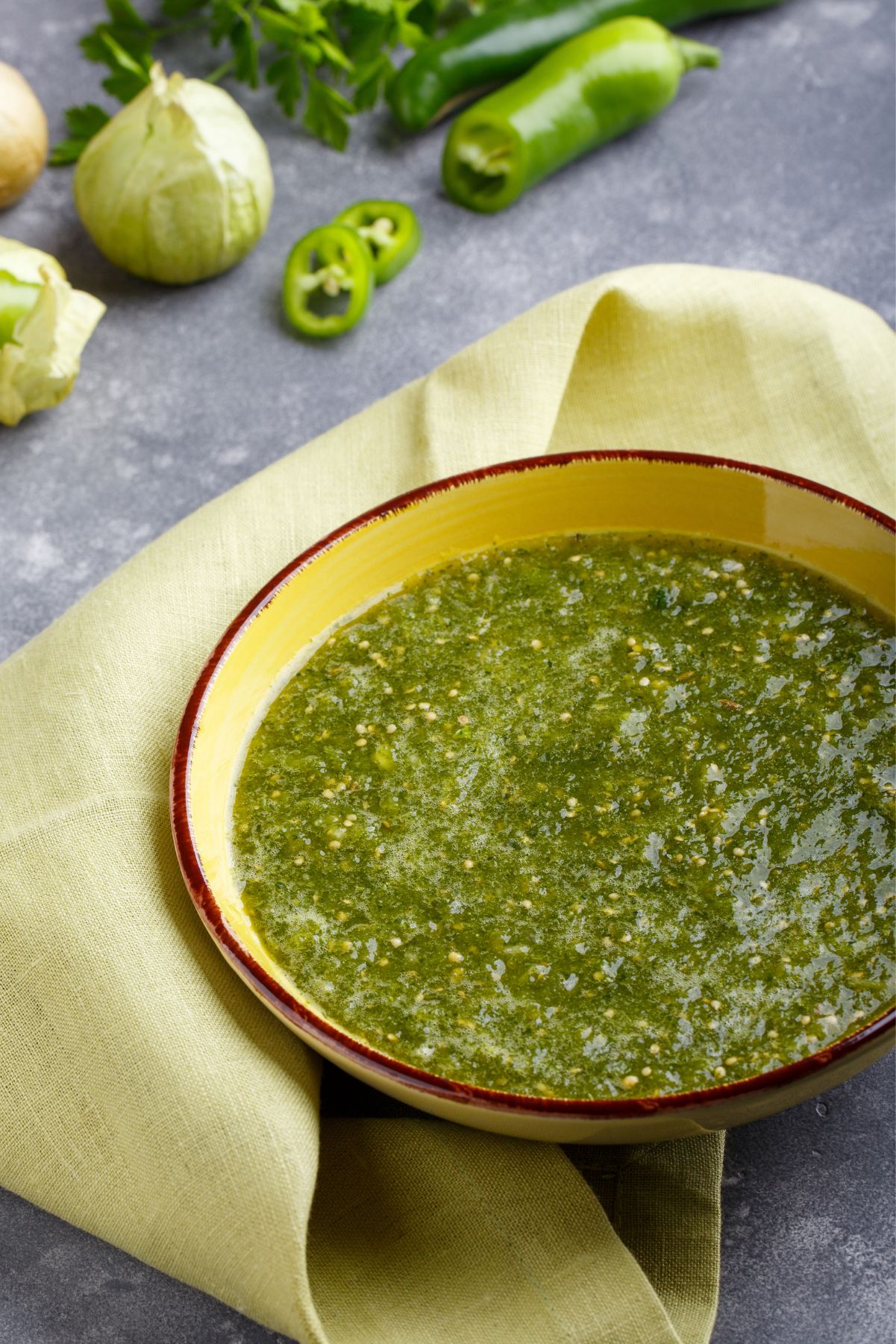 Mexican Weight Watchers Salsa Verde  in a yellow bowl sitting on a cloth napkin.