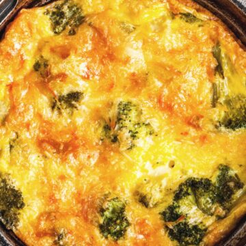 Closeup of Weight Watchers Cheesy Cheddar Broccoli Frittata in a black skillet.