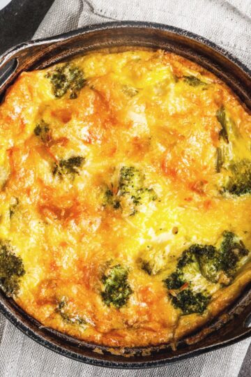 Closeup of Weight Watchers Cheesy Cheddar Broccoli Frittata in a black skillet.