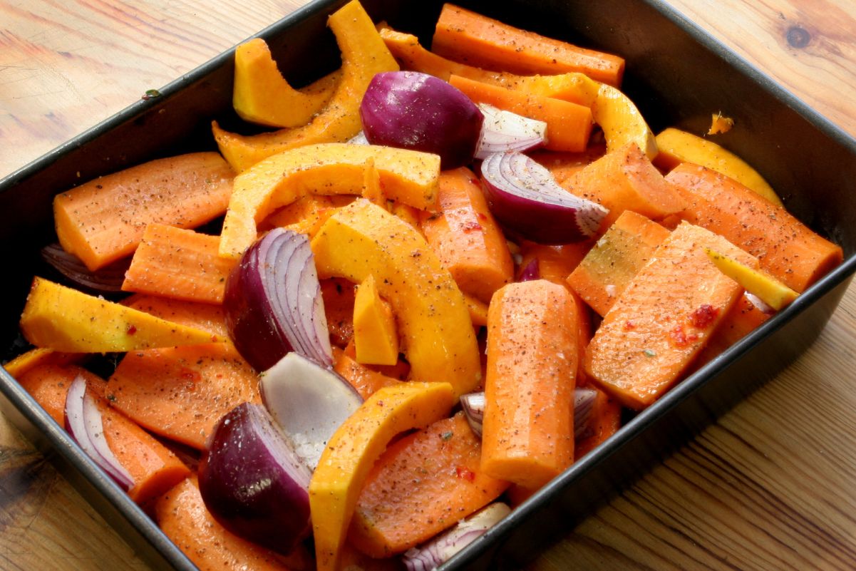 Weight Watchers Roasted Butternut Squash and Carrots in a square, black bowl on a light wooden surface.