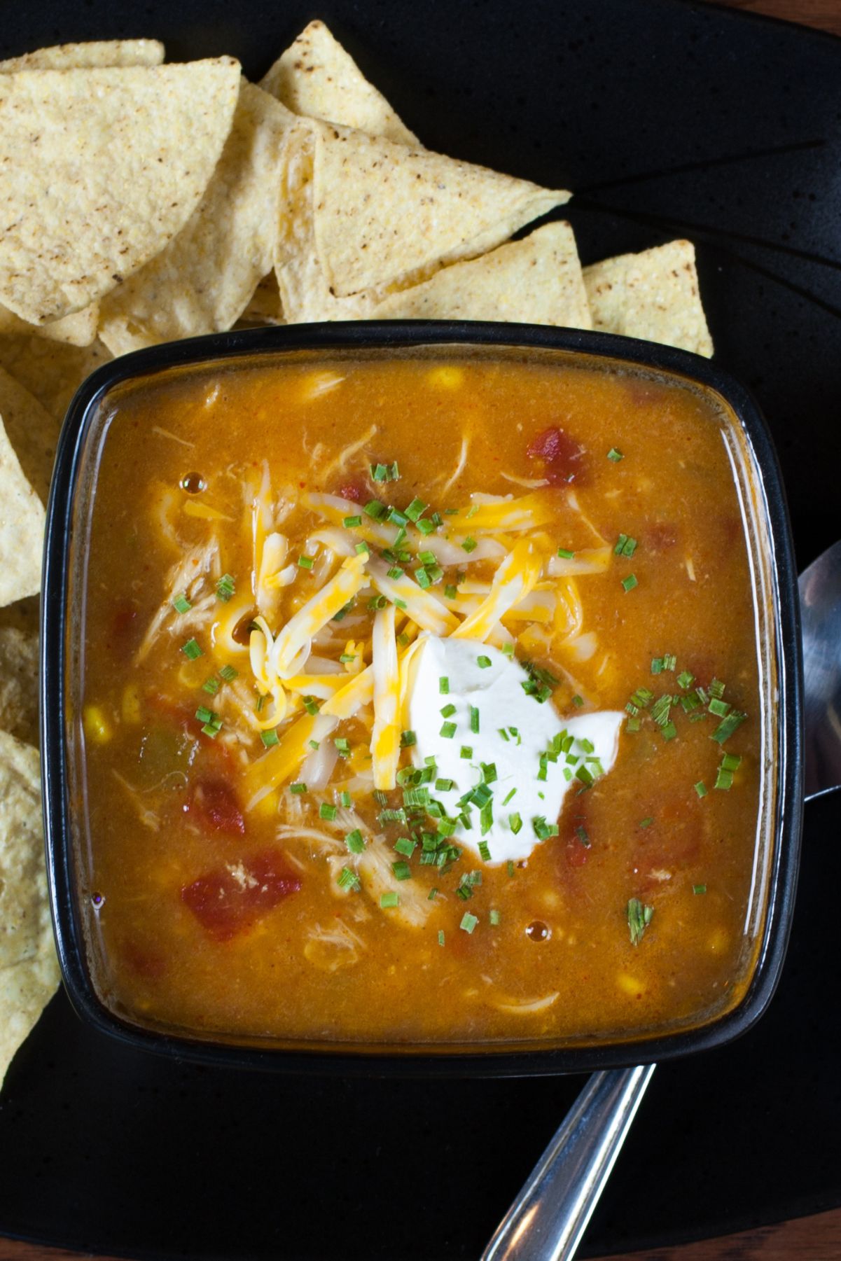 Weight Watchers Chicken Enchilada Soup in a square, black bowl.