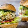 Weight Watchers Mexican Avocado Turkey Burgers on a rustic surface.