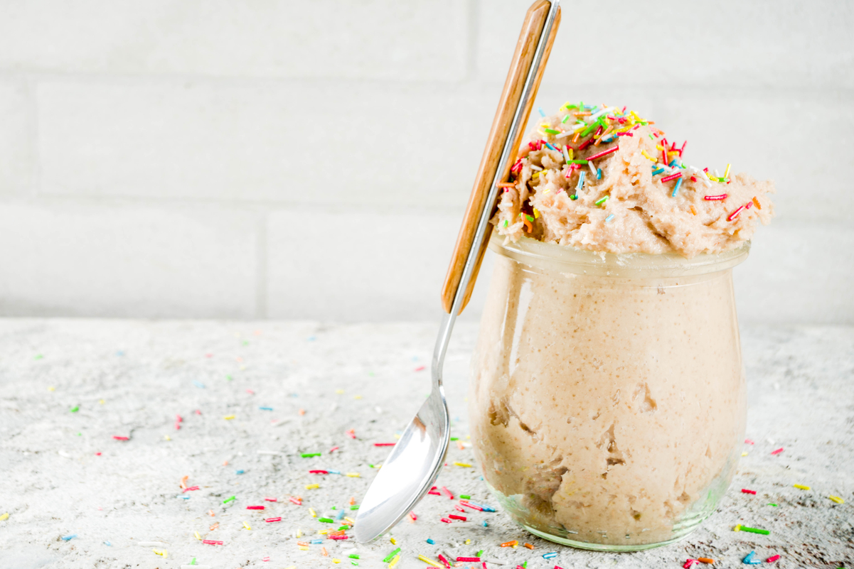 Quick and Easy Weight Watchers Confetti Cookie Dough in a clear glass with a spoon leaning on it.