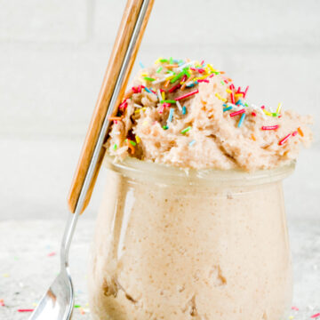 Quick and Easy Weight Watchers Confetti Cookie Dough in a clear glass with a spoon leaning on it.