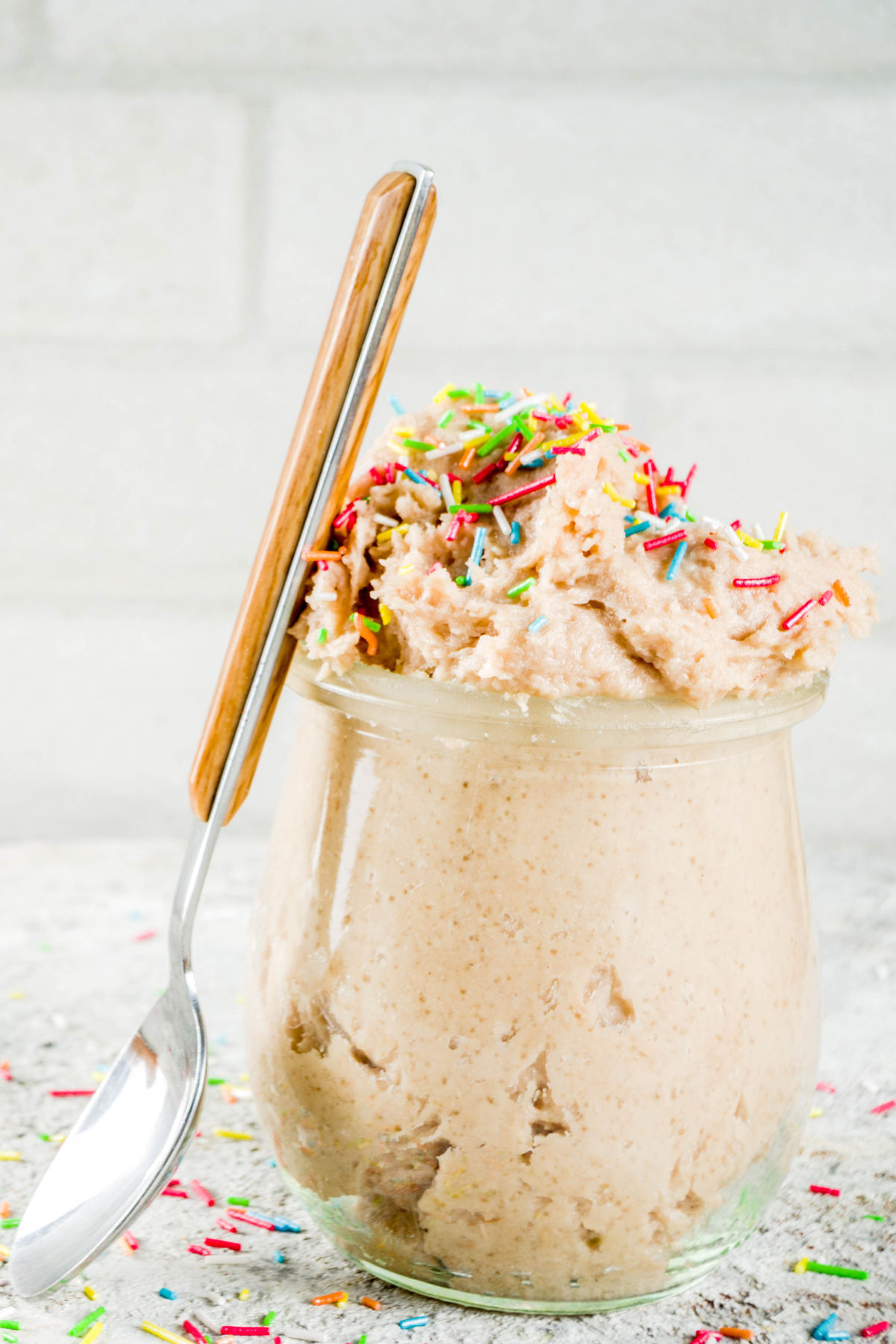 Quick and Easy Weight Watchers  Confetti Cookie Dough in a clear glass with a spoon leaning on it.