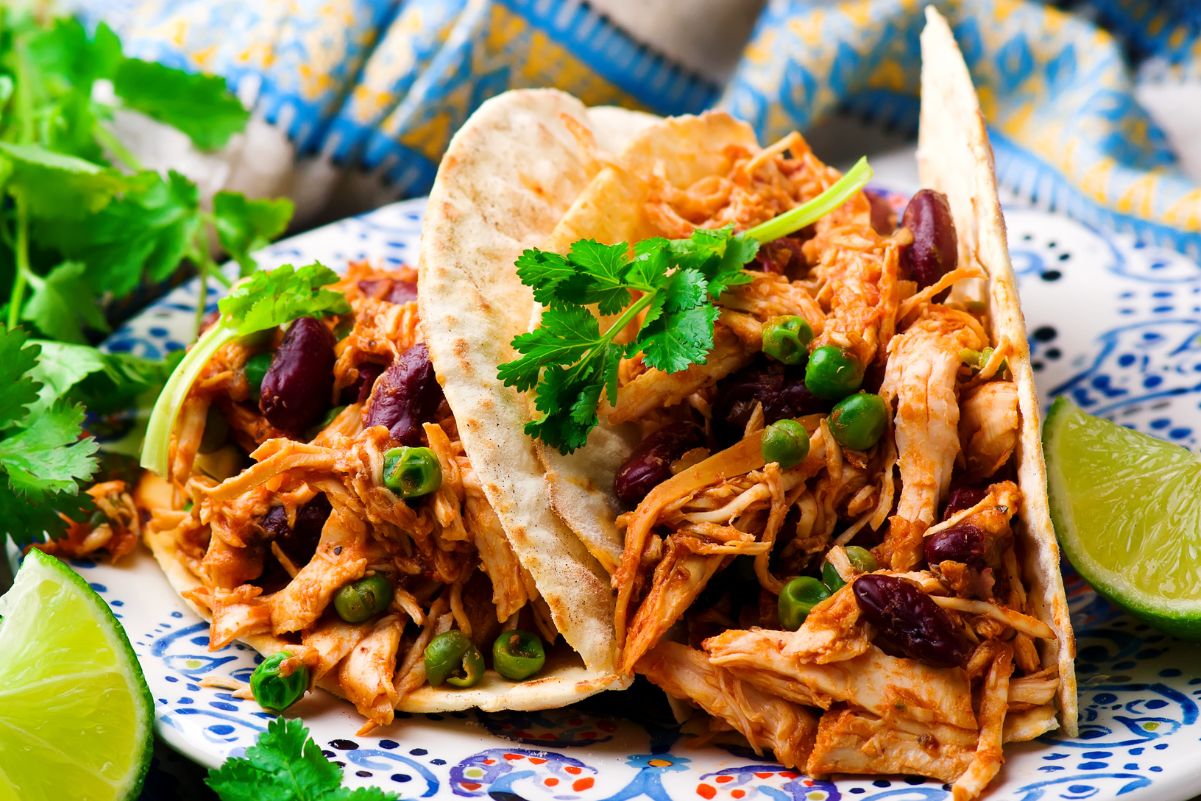 Easy Slow Cooker Chicken Tacos on a blue plate.