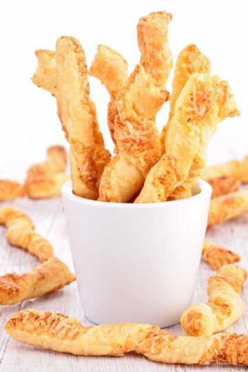 Weight Watchers Cheese Twists in a white cup on a white background.