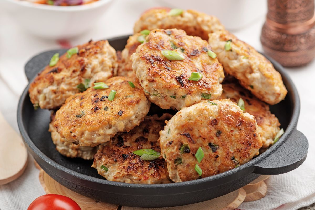 A pile of Weight Watchers Chicken Patties in a black bowl.