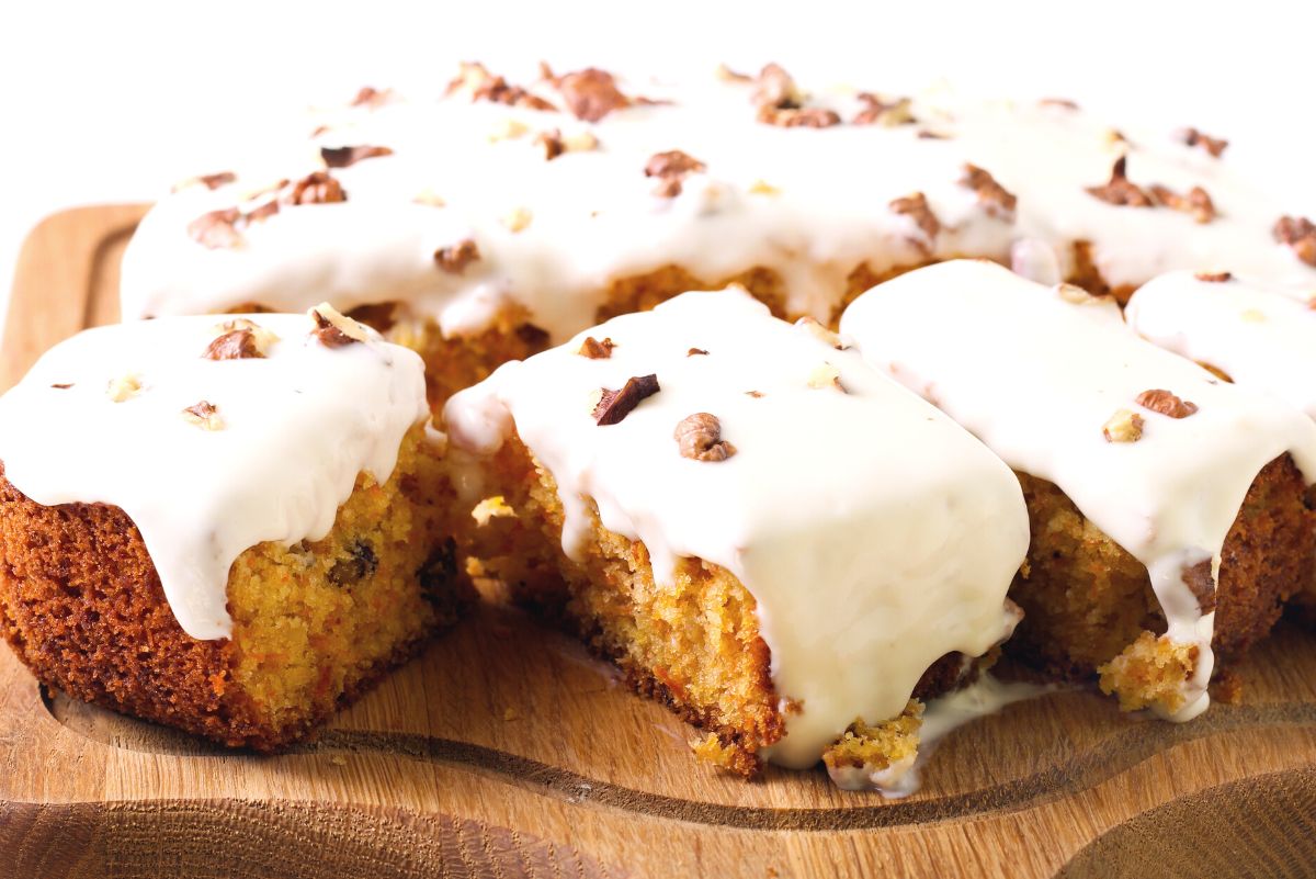 Slices of Slow Cooker Weight Watchers Carrot Cake on a wooden cutting board.