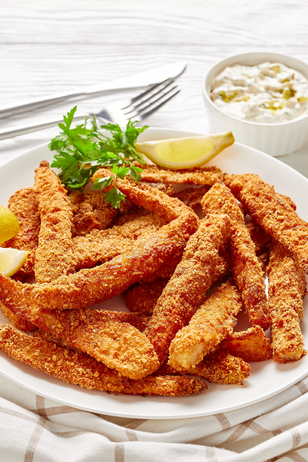 Closeup of Weight Watchers Cornmeal Breaded Fish Fingers on a white plate.