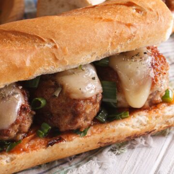 Closeup of Easy Weight Watchers Meatball Subs on a rustic wooden surface.