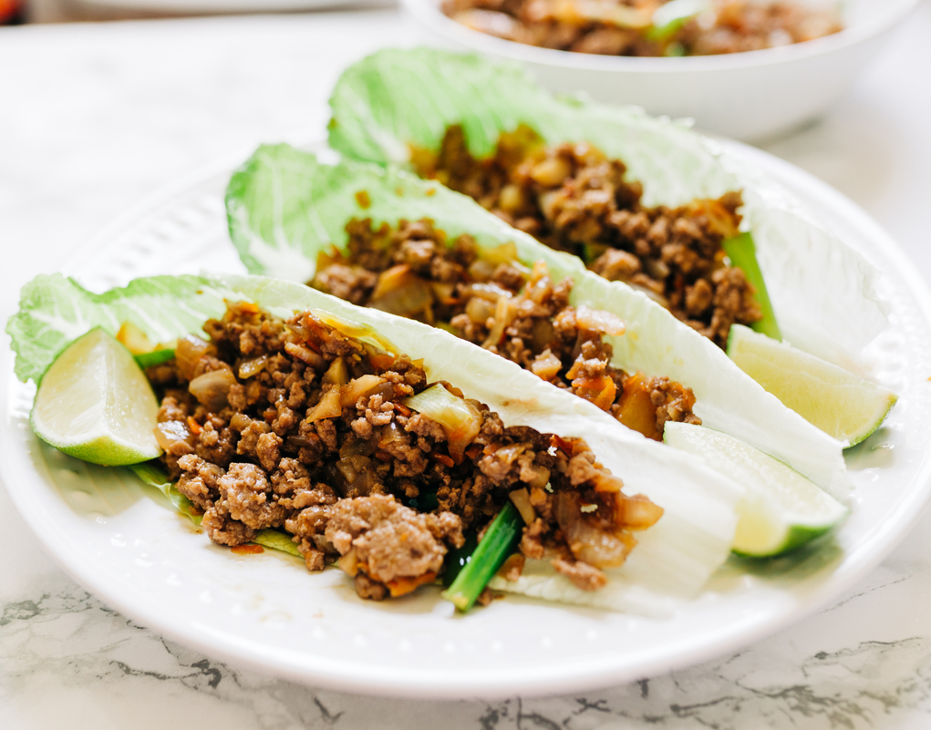 3 Weight Watchers Ginger Beef Lettuce Wraps on a white plate.