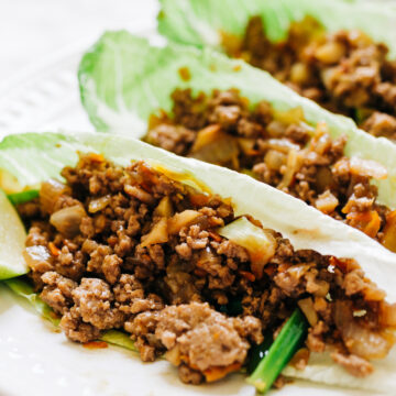 Closeup of Weight Watchers Ginger Beef Lettuce Wraps on a white surface.