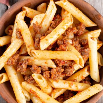 Closeup of Weight Watchers Penne Pasta with Meat Sauce in a brown bowl.