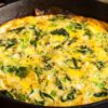 Closeup of Weight Watchers Cheddar and Spinach Frittata in a cast iron skillet.