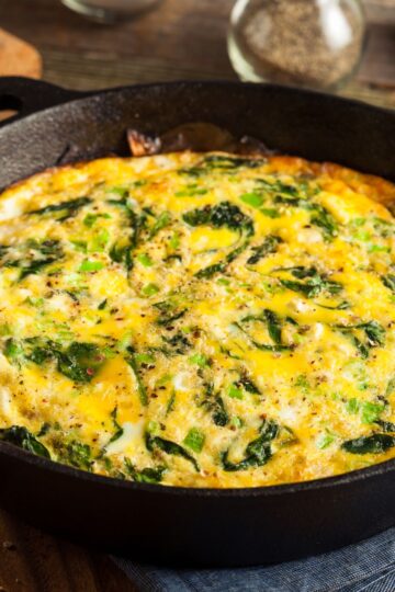 Closeup of Weight Watchers Cheddar and Spinach Frittata in a cast iron skillet.