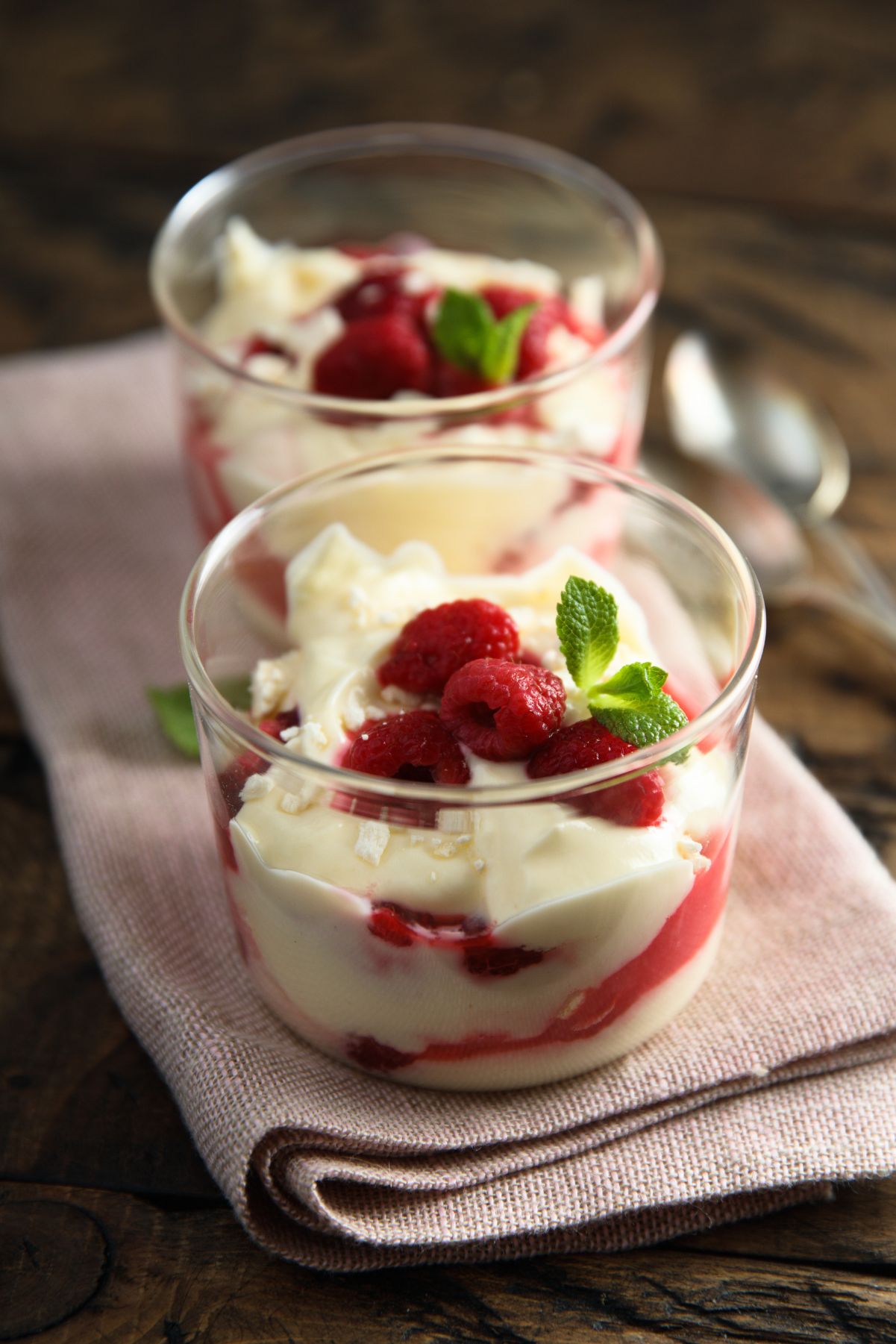 2 Weight Watchers Raspberry Pudding Cups on a cloth napkin.