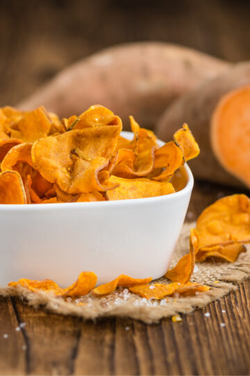Closeup of Weight Watchers Baked Sweet Potato Chips in a square, white bowl.