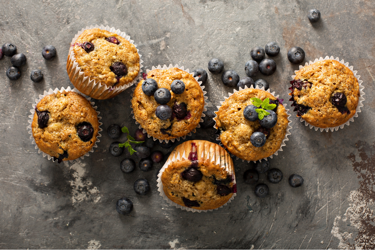 overhead view of Weight Watchers Low Fat Blueberry Muffins on a gray slate surface.