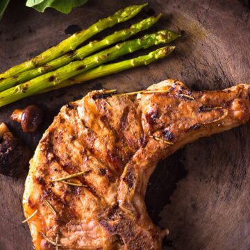 Closeup of Weight Watchers Grilled Korean Pork Chop on a dark wooden surface.