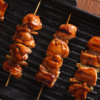 Overhead view of Simple Weight Watchers Chicken Yakitori on a black pan.