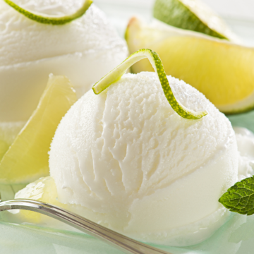 Homemade Key Lime Ice Cream (Weight Watchers) on a clear glass plate.