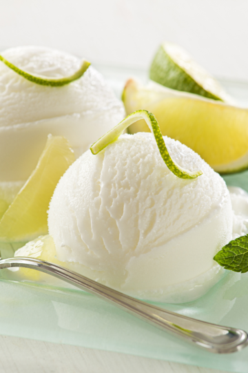 Homemade Key Lime Ice Cream (Weight Watchers) on a clear glass plate.