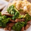 Closeup of WW Friendly Orange Sirloin Beef and Broccoli on a white plate.