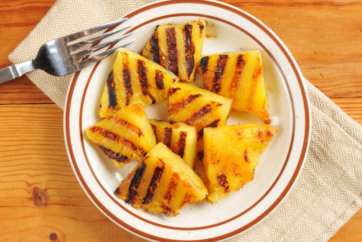 Weight Watchers Grilled Spiced Pineapple on a white plate with a fork.