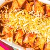 Closeup, overhead view of Weight Watchers Easy Turkey Enchiladas in a white casserole dish.