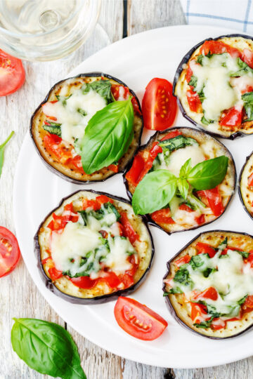 Closeup of Margherita Eggplant Pizzas (Weight Watchers) on a white plate.