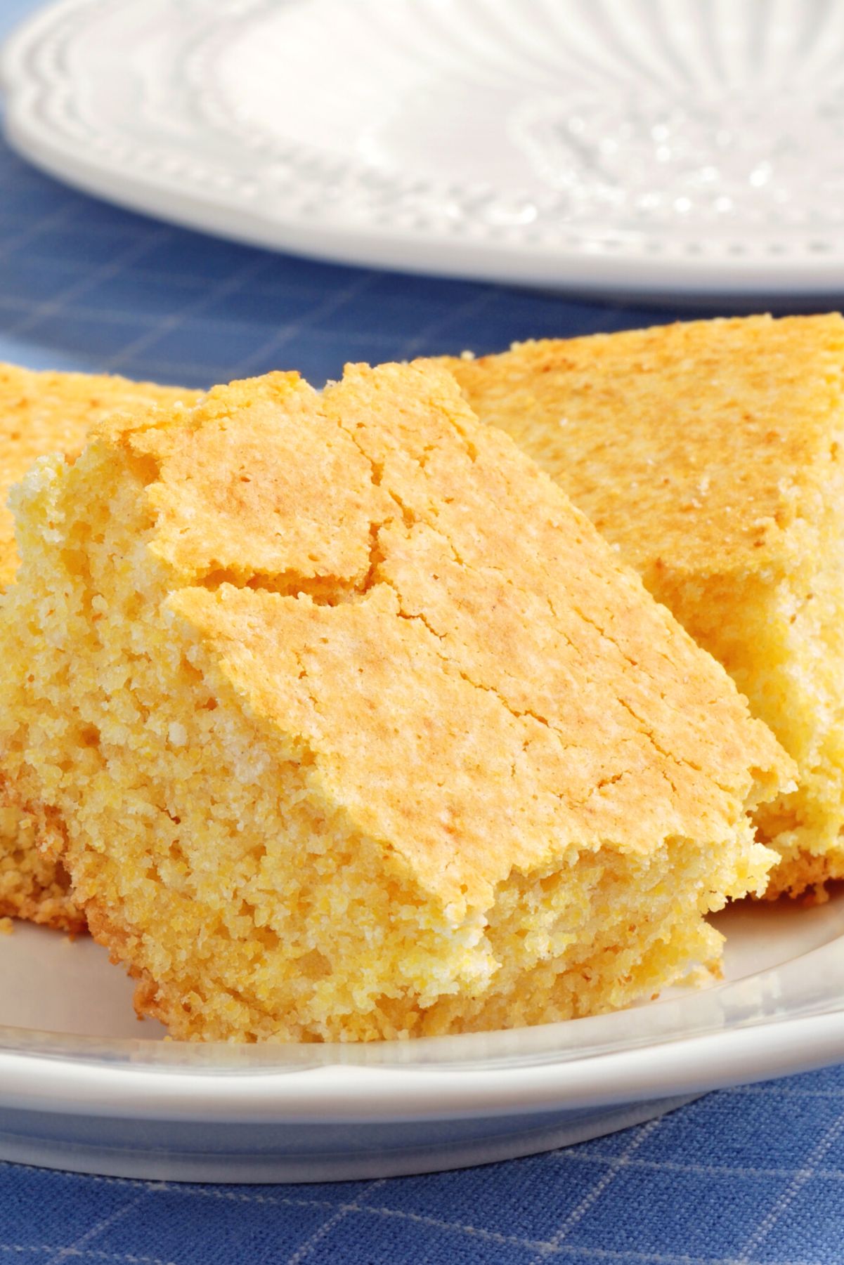 Weight Watchers Cornbread (Gluten Free) on a white plate sitting on a blue table cloth.