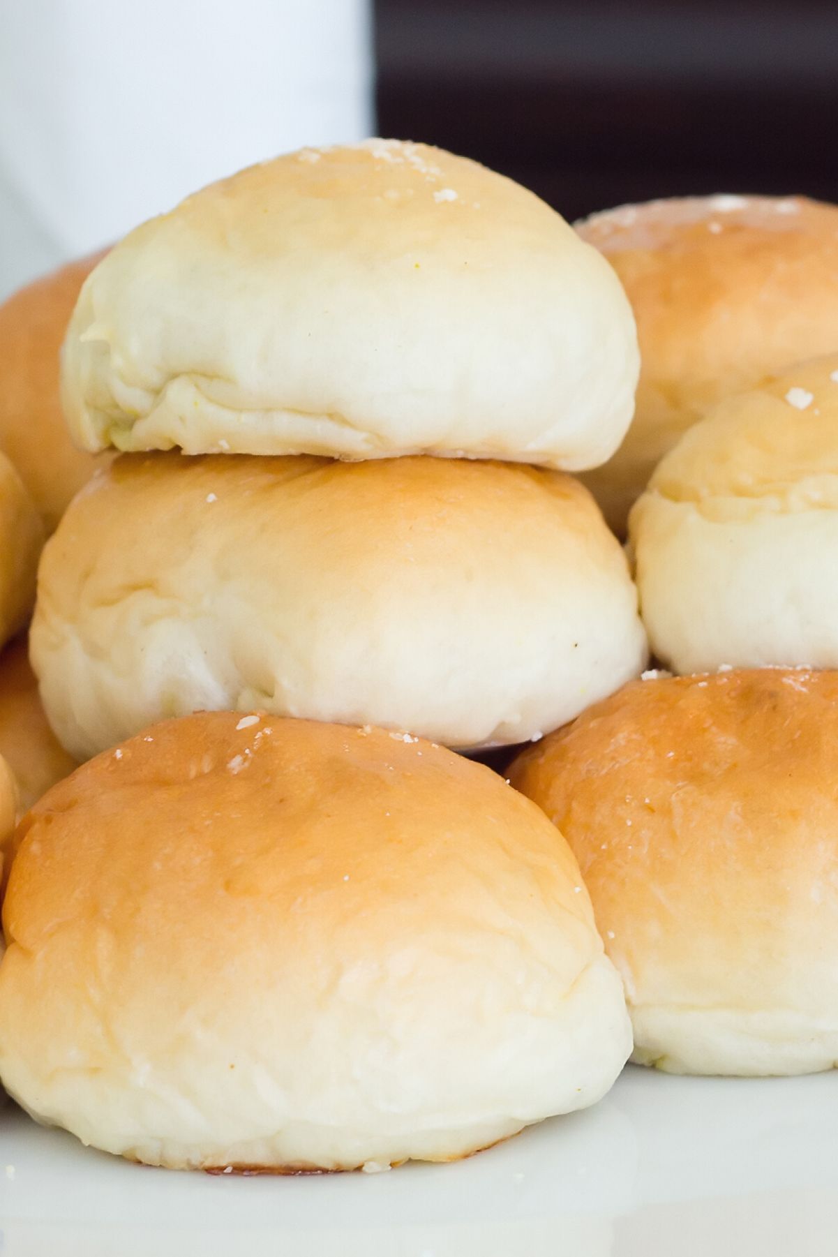 Weight Watchers Easy Dinner Rolls stacked on a white plate.