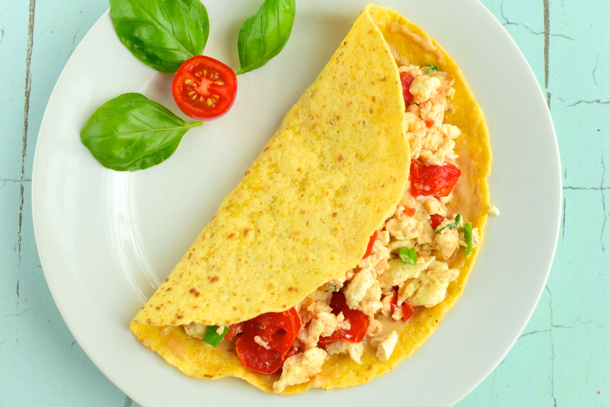 Overhead view of Weight Watchers Tomato Basil Egg Tortilla on a white plate.
