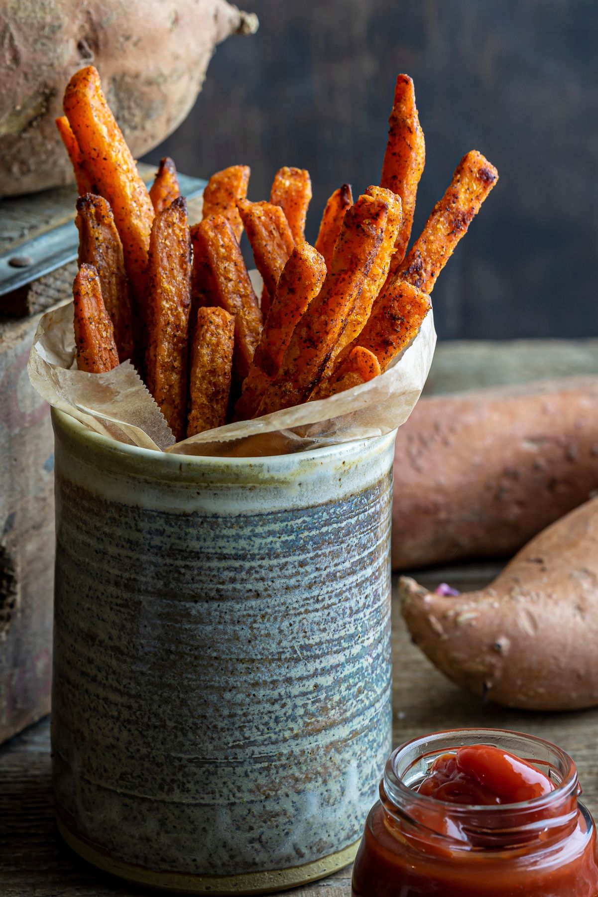 Weight Watchers Spicy Sweet Potato French Fries standing up in a gray cup.