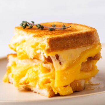 Closeup of Weight Watchers Mexican Egg and Cheese Sauce Sandwich on a white plate.