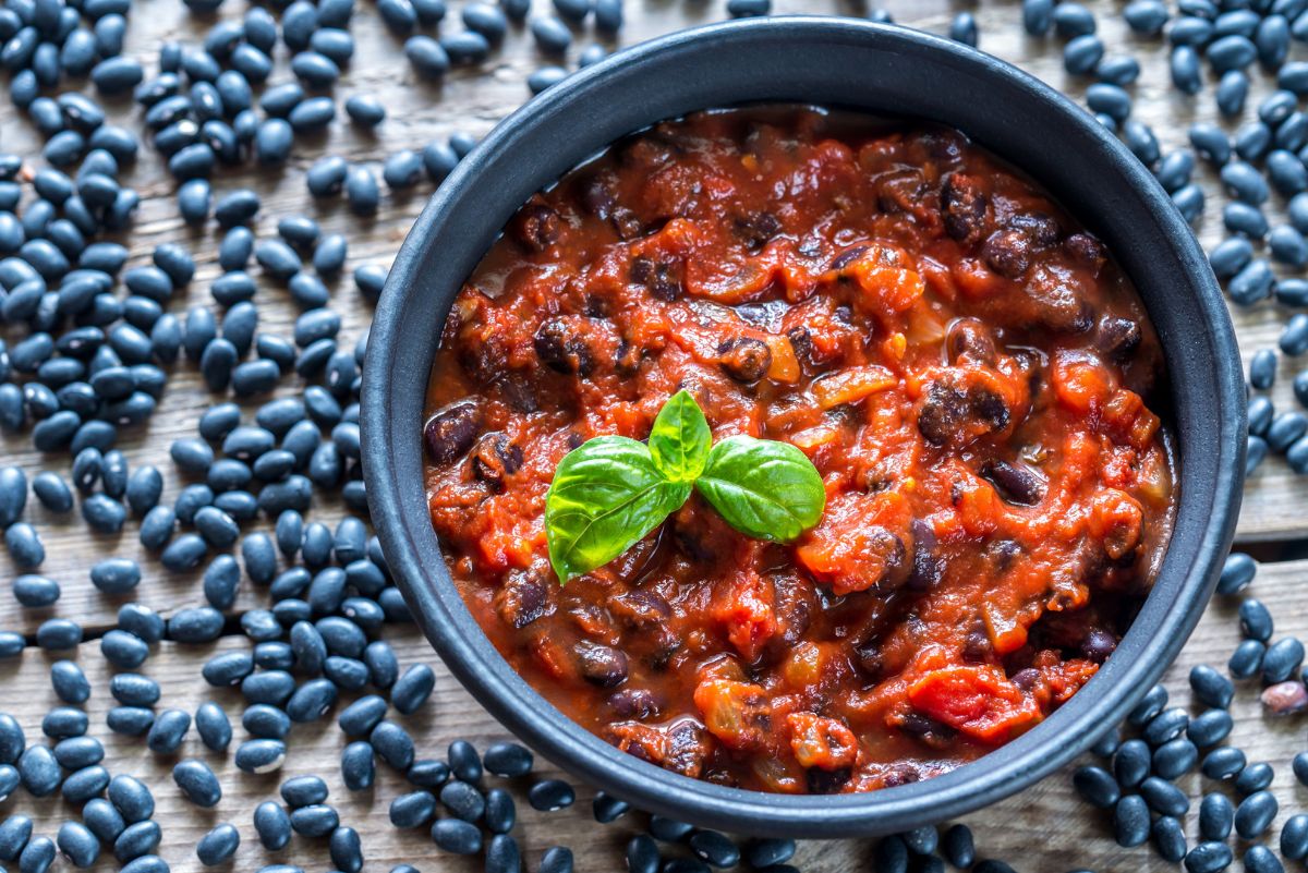 Weight Watchers Black Bean Chipotle Chili Recipe in a blue bowl surrounded by black beans.