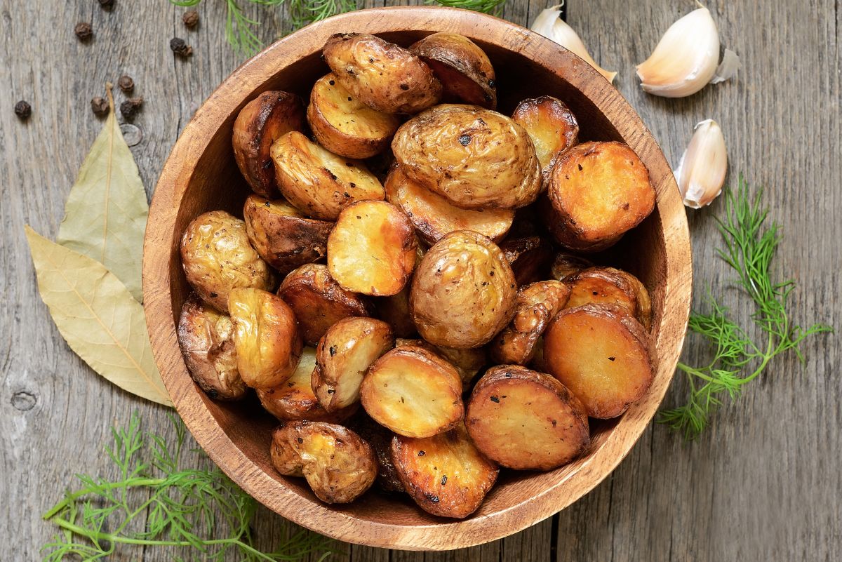 Overhead view of Weight Watchers Herb Roasted Potatoes Recipe in a wooden bowl.