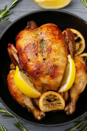 Closeup of Weight Watchers Meyer Lemon Roast Chicken in a black pot.