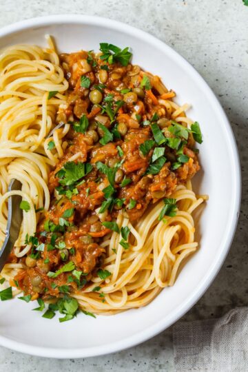Closeup overhead shot of Vegetarian Weight Watchers Pasta Bolognese on a white plate.
