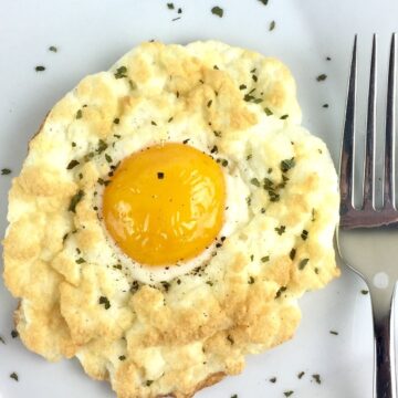 Closeup of Cheese and Herb Cloud Eggs on a white plate.