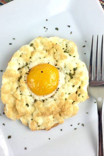 Closeup of Cheese and Herb Cloud Eggs on a white plate.