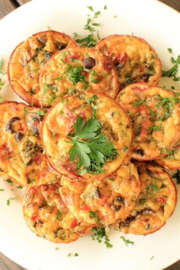 Overhead view of Zucchini bites on a white plate.