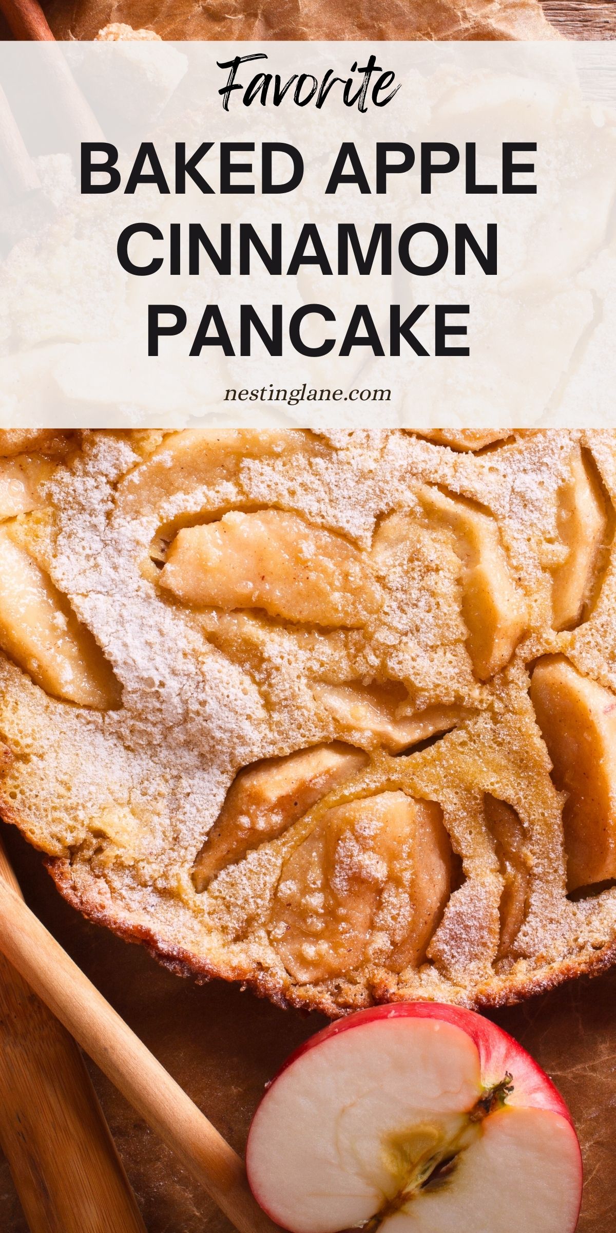 Golden baked apple cinnamon pancake dusted with powdered sugar, topped with tender apple slices baked into the surface. A fresh red apple half sits nearby on a wooden board. Text overlay reads “Favorite Baked Apple Cinnamon Pancake” with nestinglane.com below.