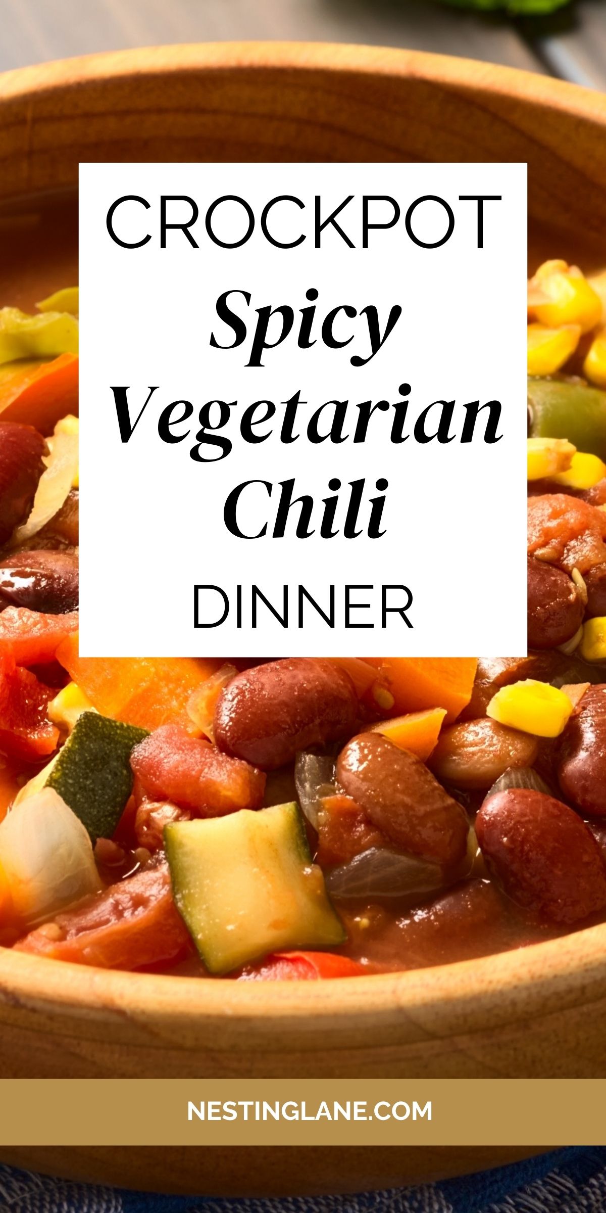 Hearty crockpot vegetarian chili filled with kidney beans, zucchini, corn, peppers, onions, and tomatoes in a rich, spicy broth. Served in a rustic wooden bowl. Center text overlay reads “Crockpot Spicy Vegetarian Chili Dinner” with nestinglane.com at the bottom.