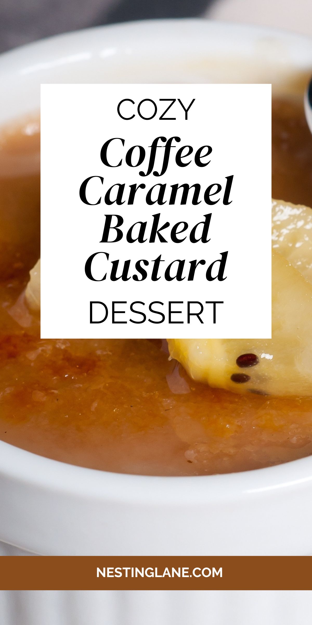 A white ramekin filled with creamy coffee caramel baked custard, topped with a golden caramelized layer and garnished with a slice of banana. A spoon rests at the edge, ready to dig in. Text overlay reads “Cozy Coffee Caramel Baked Custard Dessert” with the website NestingLane.com at the bottom.