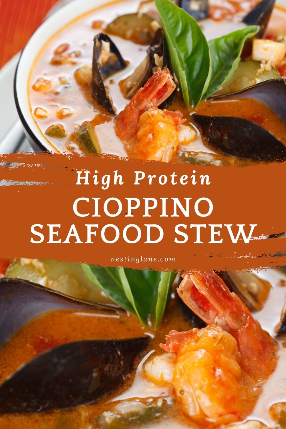 Close-up of cioppino seafood stew with shrimp, mussels, and chunks of fish in a rich tomato-based broth, garnished with fresh basil leaves. A painted rust-orange banner across the center reads “High Protein CIOPPINO SEAFOOD STEW” with “nestinglane.com” below.